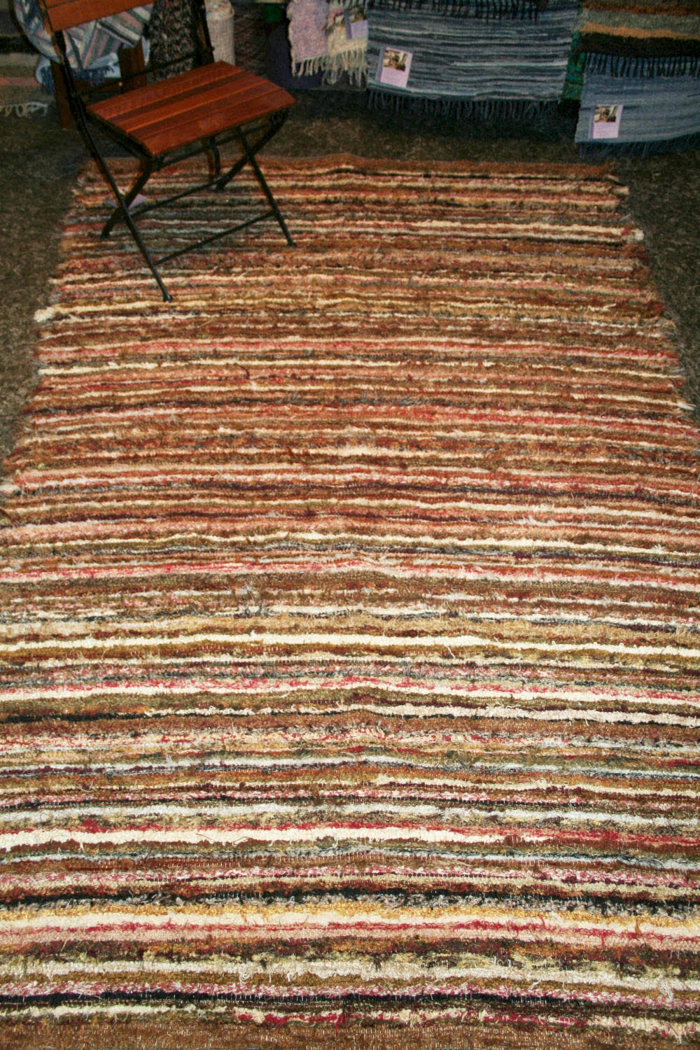 Brown and cream striped rug on a dark floor
