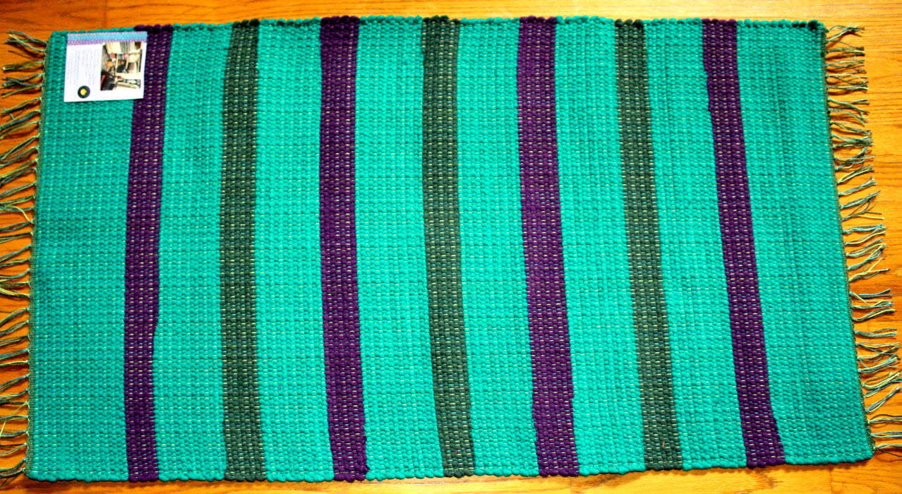 Teal rug with purple and green stripes